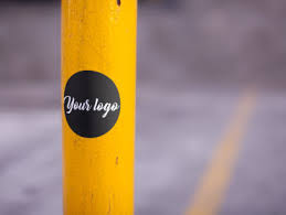Download Placeit Round Sticker On A Yellow Pole In A Parking Lot Mockup