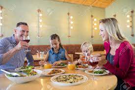 Maybe you would like to learn more about one of these? Happy Family Talking While Having Dinner At Restaurant Stock Photo Picture And Royalty Free Image Image 81575541