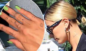 K for two pieces of delicate ink Hailey Baldwin Shows Off Intricate New Finger Tattoos And Cursive Inking On Her Neck Daily Mail Online