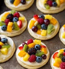 Individual Mini Fruit Pizzas Chewy Sugar Cookies Are Topped With Cream Cheese Frosting And Lo Fruit Pizza Sugar Cookie Fruit Pizza Designs Fruit Sugar Cookies