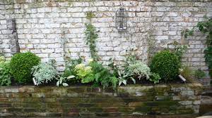Newly painted white door behind grate on fresh brick wall. Paint It White White Rendered Walls And White Fencing