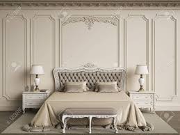 It is made of wood. Classic Bedroom Furniture In Classic Interior Walls With Mouldings Ornated Stock Photo Picture And Royalty Free Image Image 99390743