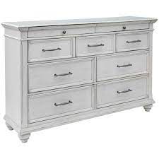 Finished with a natural stain, the dresser's clean frame embraces seven drawers fronted in ivory leather and accented with slim, horizontal pulls in antique brass. Kanwyn 7 Drawer Dresser B777 31 Ashley Furniture Afw Com