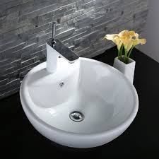 An undermount kitchen sink is installed under the counter, which creates a seamless look as there is not a rim from the sink that sits on the countertop. Bathroom Sinks Decoraport White Rectangle Ceramic Vessel Vanity Sink Porcelain Above Counter Basin Cl 1114 Vanity Sink Tops