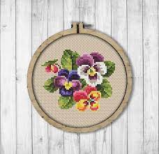 The beautiful purples and greens and corals in the collection made me think of pansies, and the result is this pretty floral pattern. Pansies Cross Stitch Pattern Pansy Cross Stitch Pattern Etsy In 2021 Cross Stitch Flowers Cross Stitch Patterns Cross Stitch