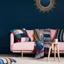 A Sophisticated Living Room With A Navy Statement Wall A Bold Modern Pink Couch And Colorfu Pink Couch Living Room Blue And Pink Living Room Teal Living Rooms