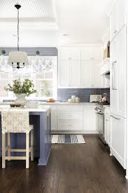 Lovely White And Blue Kitchen Features Stacked White Shaker Cabinets Mounted To Blue Ba In 2020 Kitchen Trends Kitchen Renovation Pictures Blue Tile Backsplash Kitchen