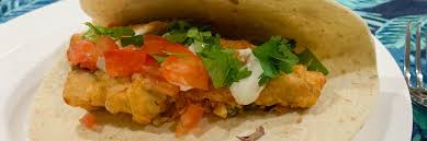 The current set up is a street stand in the front parking lot, shaded by a long white, l fish banner. Tasty Beer Battered Fish Tacos