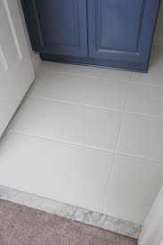 The modern aqua glaze of these ceramic tiles takes center stage in this black and white master bathroom belonging to chris and julia from the blog chris loves julia. How To Paint Tile Floor In A Bathroom Angela Marie Made