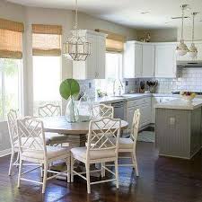 This is a dining table that has got a solid wooden construction and a stable pedestal base. Paula Deen Bungalow Round White Bamboo Dining Table