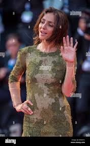 Italian actress Ambra Angiolini waves on the red carpet for the closing  ceremony of the 71st Venice International Film Festival in Venice, Italy, 6  Se Stock Photo - Alamy