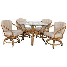 Arms or no arms armchairs add a comfort component. Vintage Rattan Game Table Set Round Glass Top Table And 4 Swivel Rolling Chairs At 1stdibs