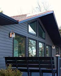 It is a good idea to replicate that same setup in your deck colors, with a dominant. Dark And Moody House Exterior With Copper Roof And Copper Sconces Love The Black Stained Deck Lake Houses Exterior Exterior House Colors House Exterior