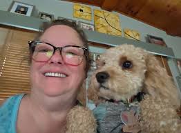 Why is my 16-month-old cockapoo growling and biting, and how can I stop  this behavior?