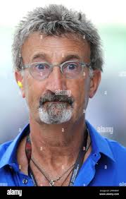 Former Formula One team owner Eddie Jordan of Britain makes a funny face  during the third timed practice session for the Malaysian Formula One Grand  Prix at the Sepang racetrack in Kuala