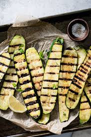 You start by slicing the zucchinis lengthwise, seasoning and grilling them. Grilled Zucchini Healthy Easy Summer Side Dish
