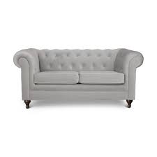 A caramel leather chesterfield sofa sits against a black wall beneath a a round brass mirror lit by a brass sconce with a white shade. Buy Habitat Chesterfield 2 Seater Velvet Sofa Light Grey Sofas Habitat