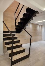 Modern Home With Staircase Metal Tread Wood Tread And Metal Railing A Wood Backdrop Soars Up The Back Of The Stair The Railin Staircase Design Home Stairs