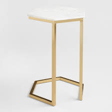 Contoured with an open, geometric angled body in a soft gold finish and an antiqued hexagonal mirror tabletop, it instantly upgrades the aesthetic of any room in the house. Marble And Gold Margaux Laptop Table World Market
