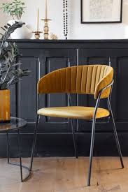 Featuring velvet upholstery, welted trim and attractive tapered metal legs, the marcel velvet dining chairs blend simplicity, comfort and luxury to add creative energy to spaces big and small. Curved Back Velvet Dining Chair In Golden Ochre Rockett St George