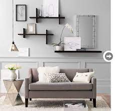 A blank area was left above the sofa to allow for sconces and art. Wall Decor How To Fill Your Blank Walls Style At Home Floating Shelves Living Room Wall Shelves Living Room Wall Decor Living Room
