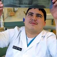 Lt. Joseph Reardon applies anesthetics to a patient's gum.