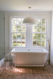 Terracotta tiles have been around forever but most homeowners prefer the trending porcelain, vitrified or stone tiles instead of terracotta for the flooring of urban homes. Empire Bathtub On Terracotta Tiles Transitional Bathroom