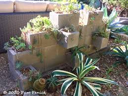 For a crack, use the brush to remove loose pieces of concrete and mortar. Cinderblock Succulent Wall Deconstruction Digging