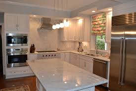 Some homeowners may prefer to choose their solid stone backsplash from a complementary color or pattern. White Carrara Marble Countertops Complimented By Matching Full Height Backsplash Marble Counterto Carrara Marble Countertops Marble Countertops Stone Gallery