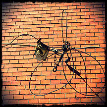 The brick is abrading the wiring, plus its an open hole to the panel and inside of the house so water/fire issues. Cable At Brick Wall Stockphoto