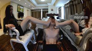 Two smoking hot Asian girls in sophisticated outfits found a perfect foot  slave for Sunday night