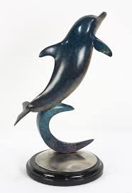Special order only, a beautiful scultpure of 12 dolphins swimming with a special, vivid color patina finish. Dale Evers Patinated Bronze Figural Sculpture Of A Dolphin Lofty Marketplace