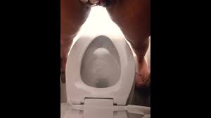 Her Standing to Piss in Toilet