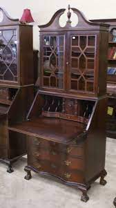 A secretary desk or escritoire is made of a base of wide drawers topped by a desk with a hinged desktop surface, which is in turn topped by a bookcase usually closed with a pair of doors, often made of glass. Secretary Desk Antique Secretary Desks Vintage Secretary Desk Secretary Desks