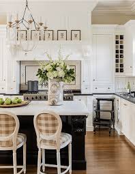 The fashionable bar stool is just the thing for kitchen hangouts and informal dining. Jackie Whalen Interiors Classic White Kitchen Island Bar Stools Brown White Buffalo Check Plaid Gingham Upholstery The Glam Pad