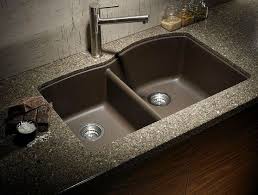 A strong water jet flows into the basin. Modern Kitchen Sink Tiles Design