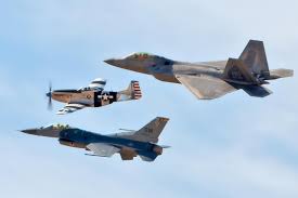 A navy growler jet,designed to jam enemy radars. F 22 Raptor Flies Alongside An F 16 Fighting Falcon And A P 51 Mustang 2249x1500 Warplaneporn