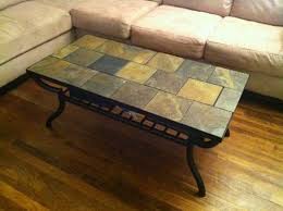 A mosaic tiled coffee table has a metal base and a white marble top. Slate Tile Table Tile Tables Tile Top Tables Slate Top Coffee Table