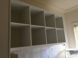 Ikea kallax mounted on the wall with two white painted steel brackets in the top corners. Ikea Hack Mounting Kallax On The Wall Ikea Kallax Shelving Ikea Hack Storage Ikea Wall Cabinets