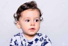 Portrait Of A Cute Curly Hair Baby Boy Looking Away Adorable One Year Old Child Looking