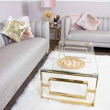A coffee table is a low table designed to be placed in a sitting area for convenient support of beverages, remote controls, magazines, books (especially large, illustrated coffee table books), decorative objects, and other small items. Plaza Gold Contemporary Clear Glass Lounge Coffee Table Picture Perfect Home