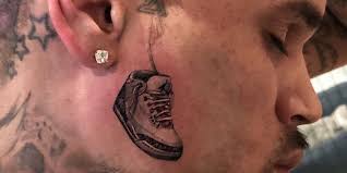 It's definitely a woman with almond shaped eyes, full lips, and soft features—while this could definitely pass for rihanna, it could also just be a generic drawing. Chris Brown Shows Off His New Face Tattoo Of An Air Jordan Sneaker People Com