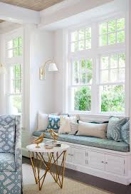 Colorful pillows can be added to brighten things up and contrast against the light wood color of the window bench. Window Seat Bench With Round Brass Accent Table Transitional Living Room
