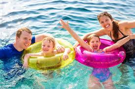 Download Premium Image Of Family Playing In A Pool 429077 Family Swimming Pool Family Images