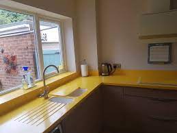 The kitchen is not the only place where wood worktops can be used. Corian Worktops In Imperial Yellow With Intergrated Sinks