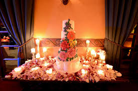 Cake Table With Rose Petals And Candles Table Decorations Cake Table Rose Wedding