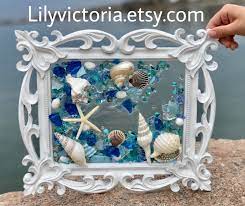 Silver conch shell with ornate dragon. Pin On Beach Decor