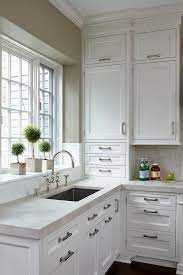 Crisp White Shaker Cabinets Go To The Ceiling In This White Kitchen And Create A Spacious Feel While W White Kitchen Design Kitchen Renovation Kitchen Remodel