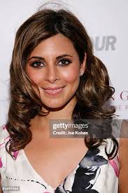 Stilt dancers Kae Burke and Ali Schmitz pose for a photo with Glamour...  News Photo