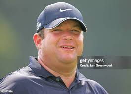 TOUR rules official Steve Carman holds the flag so Tiger Woods can... News  Photo